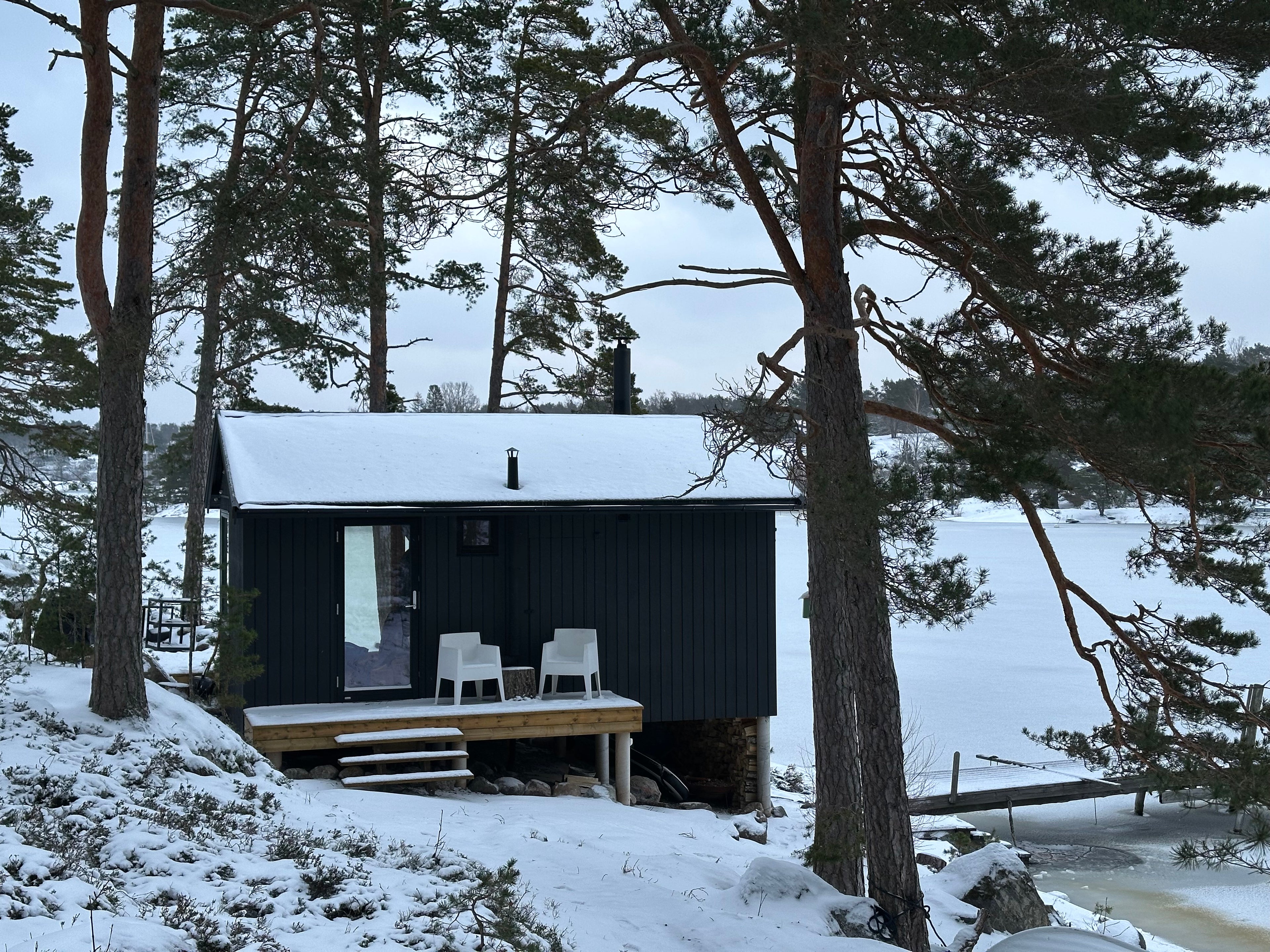 Sauna cabin on rocky shoreline in winter, Stockholms skärgård