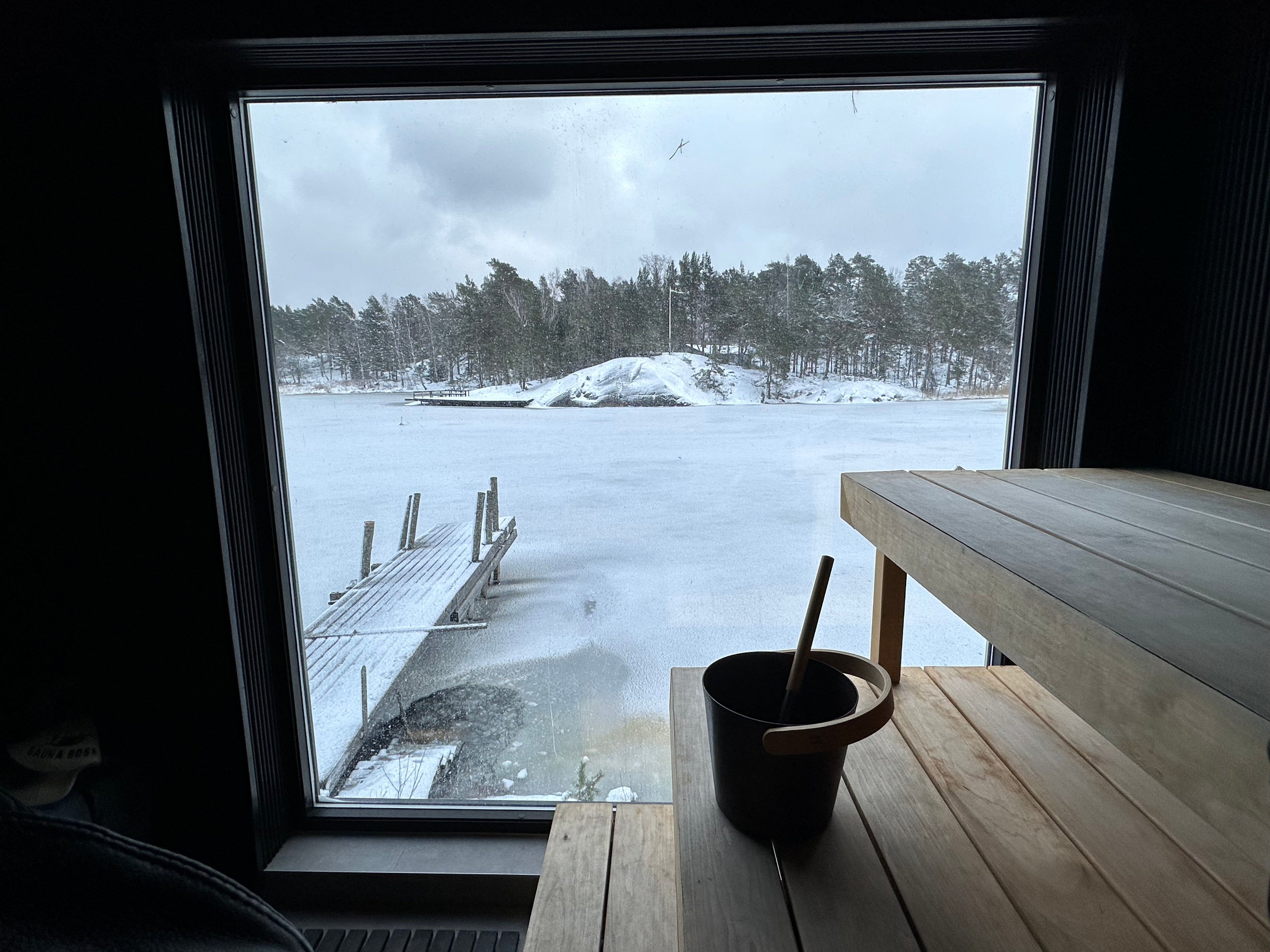 Winter view of frozen Baltic sea from a sauna window