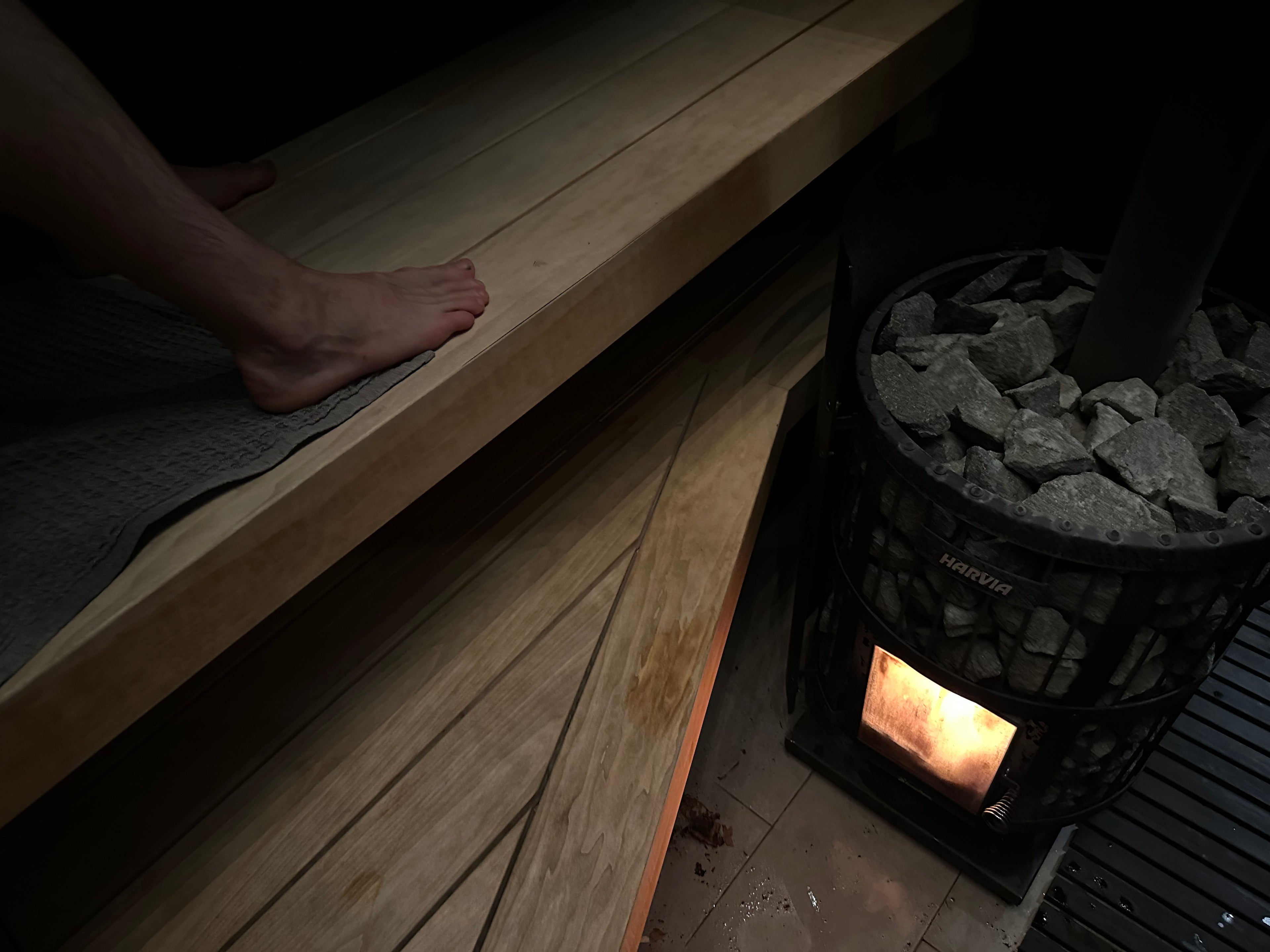Harvia wood-burning sauna stove with glowing embers